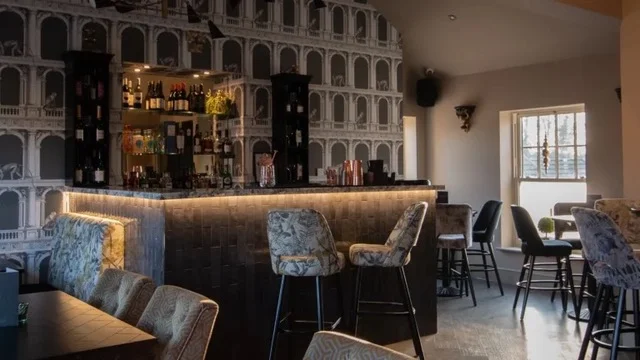 The events room bar, lit from below, with patterned bar stools